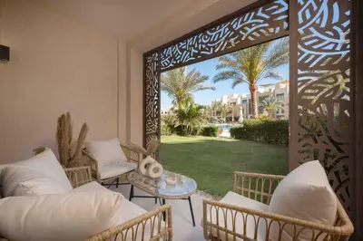 a living room with a view of a yard at Mangroovy Stays El Gouna - BirdNest in Hurghada