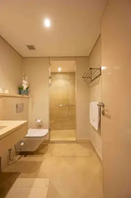 a bathroom with a shower and a toilet and a sink at Mangroovy Stays El Gouna - BirdNest in Hurghada