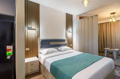 a bedroom with a large bed and a television at Al Saraya Sahl Hasheesh by Peaks Studio with Pool View C106 in Hurghada