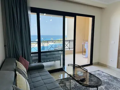 a living room with a couch and a view of the ocean at Beautiful Island View in Hurghada