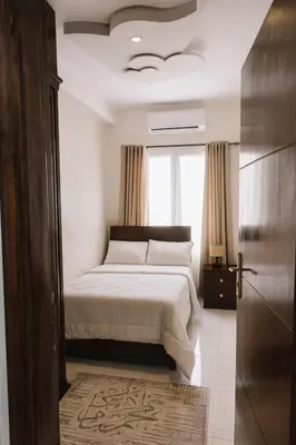a bedroom with a bed and a window at Al FAHAD private apartments for rent in Luxor