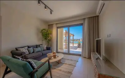 a living room with a couch and a table at Luxury Stays in Shedwan El Gouna in Hurghada