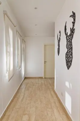 an empty room with white walls and a wooden floor at Luxury Villas in Joubal El Gouna in Hurghada