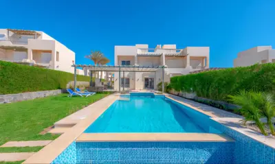 a swimming pool in front of a house at Luxury Villas in Joubal El Gouna in Hurghada