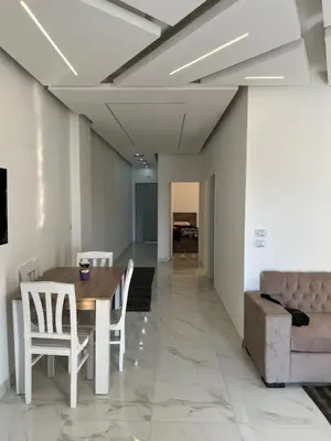 a dining room with a table and chairs and a couch at White House in Hurghada