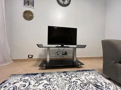 a tv sitting on a table in a living room at ATO luxurious apartments in Hurghada