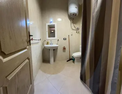 a bathroom with a sink and a toilet at ATO luxurious apartments in Hurghada