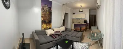 a living room with a couch and a table at ATO luxurious apartments in Hurghada