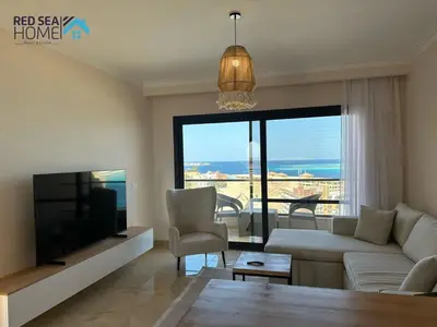 a living room with a couch and a tv at Luxury Apartment In The View in Hurghada