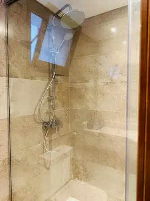 a bathroom with a shower with a glass door at Luxury Apartment In The View in Hurghada