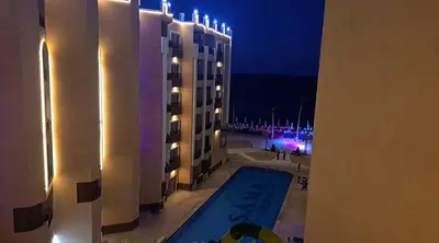 a view of a swimming pool from a building at night at Stylish studio with sea view in Hurghada