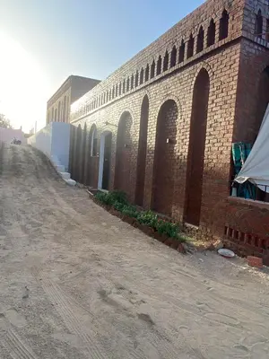 a brick building with arches on the side of it at Nile Garden Apartments in Luxor