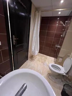 a bathroom with a toilet and a bath tub at Luxury One Bed Room Apartment in Hurghada