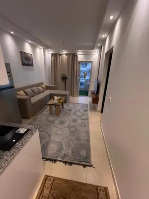 a living room with a couch and a table at Luxury One Bed Room Apartment in Hurghada