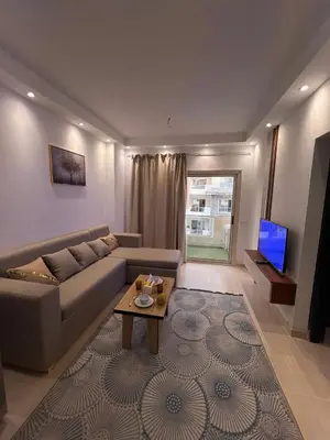 a living room with a couch and a table at Luxury One Bed Room Apartment in Hurghada