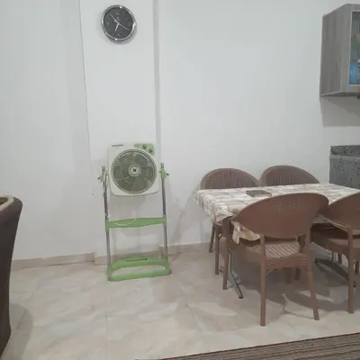 a dining room with a table and a fan at الغردقة الانتر in Hurghada