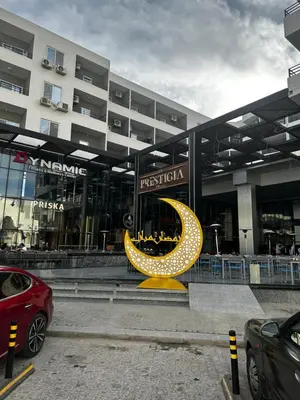 a large building with a yellow moon sculpture in front of it at Central Hurghada Studios in Hurghada