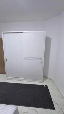 a white door in a room with a black rug at Central Hurghada Studios in Hurghada