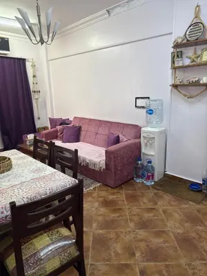 a living room with a couch and a table at Hurghada cozy apartment in Hurghada