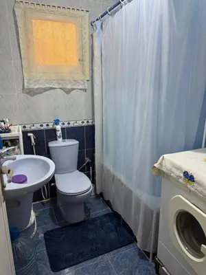 a bathroom with a toilet and a sink and a shower at Hurghada cozy apartment in Hurghada