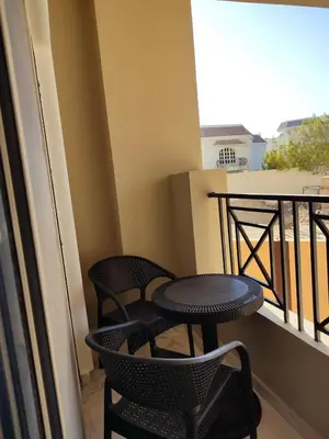 two chairs and a table on a balcony at Perfect studio for holiday in Hurghada