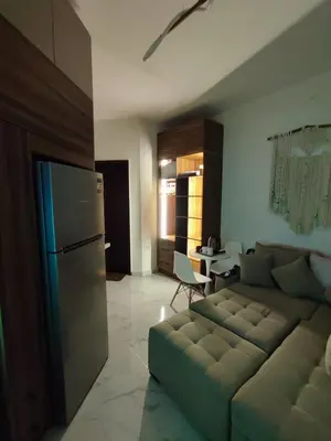a living room with a couch and a kitchen at Perfect studio for holiday in Hurghada