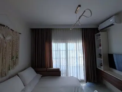 a bedroom with a bed and a large window at Perfect studio for holiday in Hurghada
