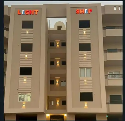 a tall building with a sign on the side of it at Apartment in Hurghada , Ahyaa, , in front of Royal beach in Hurghada