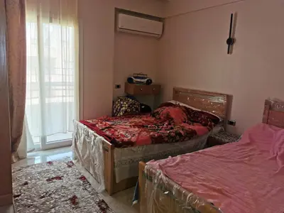 a bedroom with two beds and a window at Apartment in Hurghada , Ahyaa, , in front of Royal beach in Hurghada