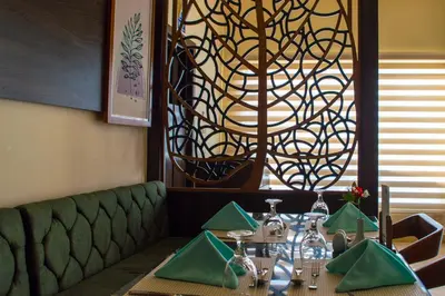 a dining room with a table and a chandelier at Oyster bay resort studio in Marsa Alam