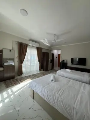 a large bedroom with a large bed and a television at Villa Pure Luxor in Luxor