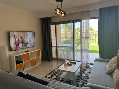 a living room with a couch and a table at The view -Clubhouse in Hurghada