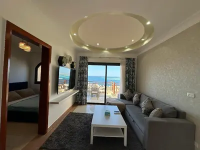 a living room with a couch and a table at The view -Nubian One bedroom in Hurghada