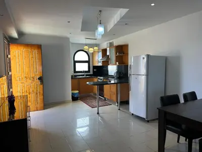 a kitchen with a refrigerator and a table in it at The Nubian Sea View in Hurghada
