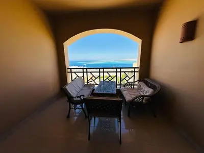 a room with a table and chairs and a window at The Nubian Sea View in Hurghada