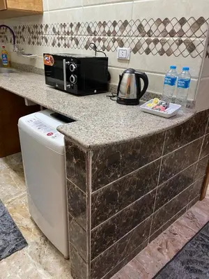 a kitchen with a counter with a toaster and a microwave at Luxe Nest Luxor Serviced Apartments 102 in Luxor