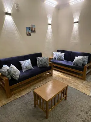 a living room with two couches and a coffee table at Luxe Nest Luxor Serviced Apartments 102 in Luxor