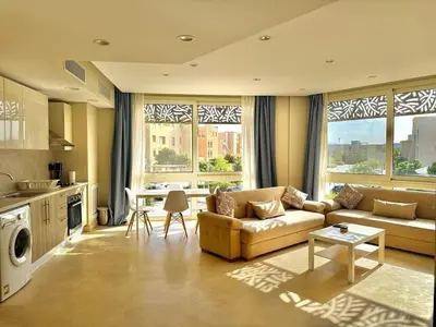 a living room with a couch and a table at One bedroom Mangroovy El Gouna in Hurghada