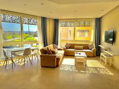 a living room with a couch and a table at One bedroom Mangroovy El Gouna in Hurghada