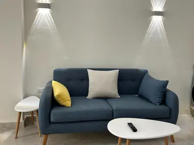 a blue couch in a living room with two lights at Hurghada Concierge at Fiesta Beach Resort 411 in Hurghada