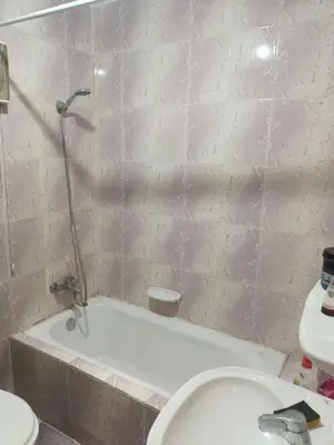 a bathroom with a white tub and a toilet at fayrouz apartment in Jazīrat al ‘Awwāmīyah
