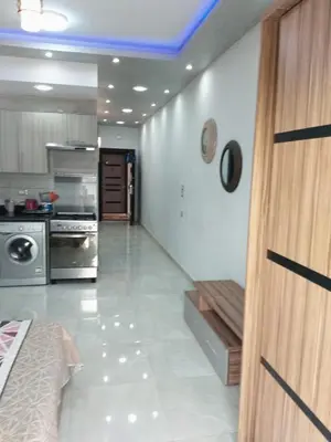 a room with a kitchen with a bed and a stove at Compound El makramia 504 in Hurghada