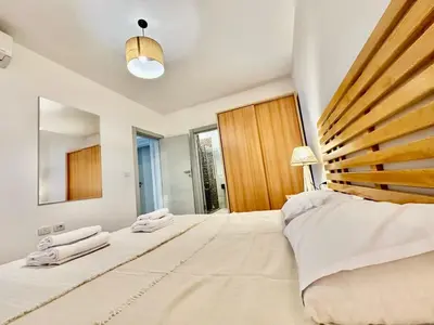 a bedroom with a large bed and a mirror at Cozy 2 bedroom Sholan 1 - Gouna in Hurghada