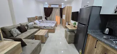a kitchen and living room with a couch and a table at Tiba Golden Resort Hurghada in Hurghada
