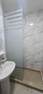 a bathroom with a sink and a shower at Tiba Golden Resort Hurghada in Hurghada