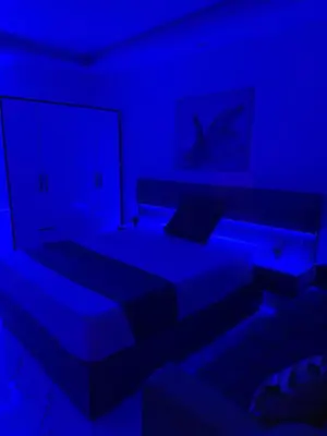 a blue room with a bed and a couch at Palma Resort Hurghada in Hurghada