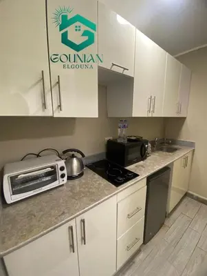a kitchen with a counter top with a microwave at Cozy studio in Bali in Hurghada