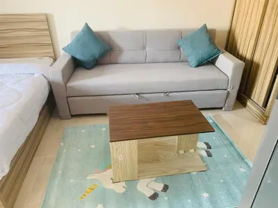 a living room with a couch and a coffee table at Sam and Sami studio apartment in Hurghada