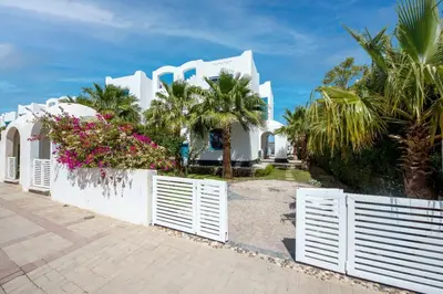 a white fence in front of a white house at Sahlhasheesh villa with heated pool and Jacuzzi in Hurghada