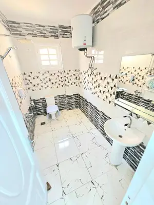 a white bathroom with a sink and a mirror at Marina Views Hurghada in Hurghada